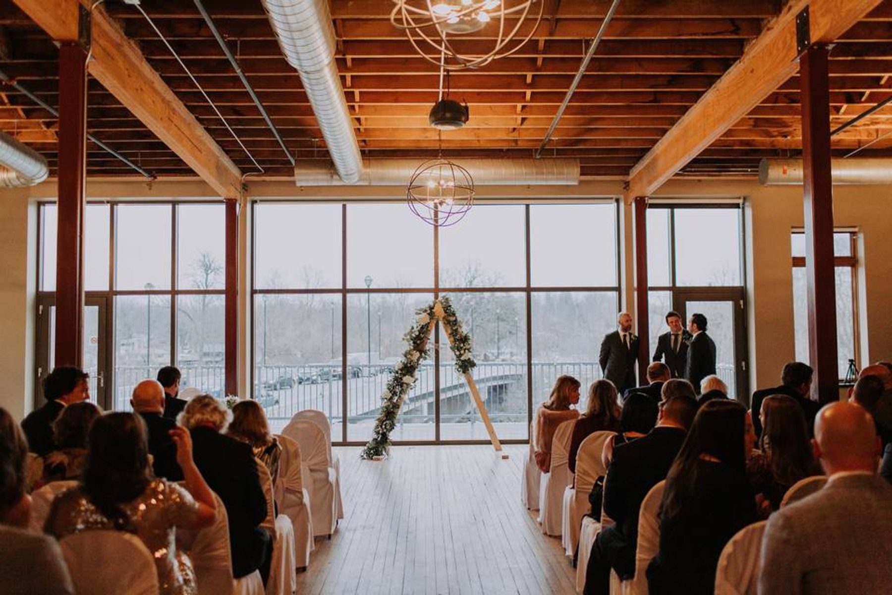Warm candlelight and uplighting throughout the historic River's Edge reception room